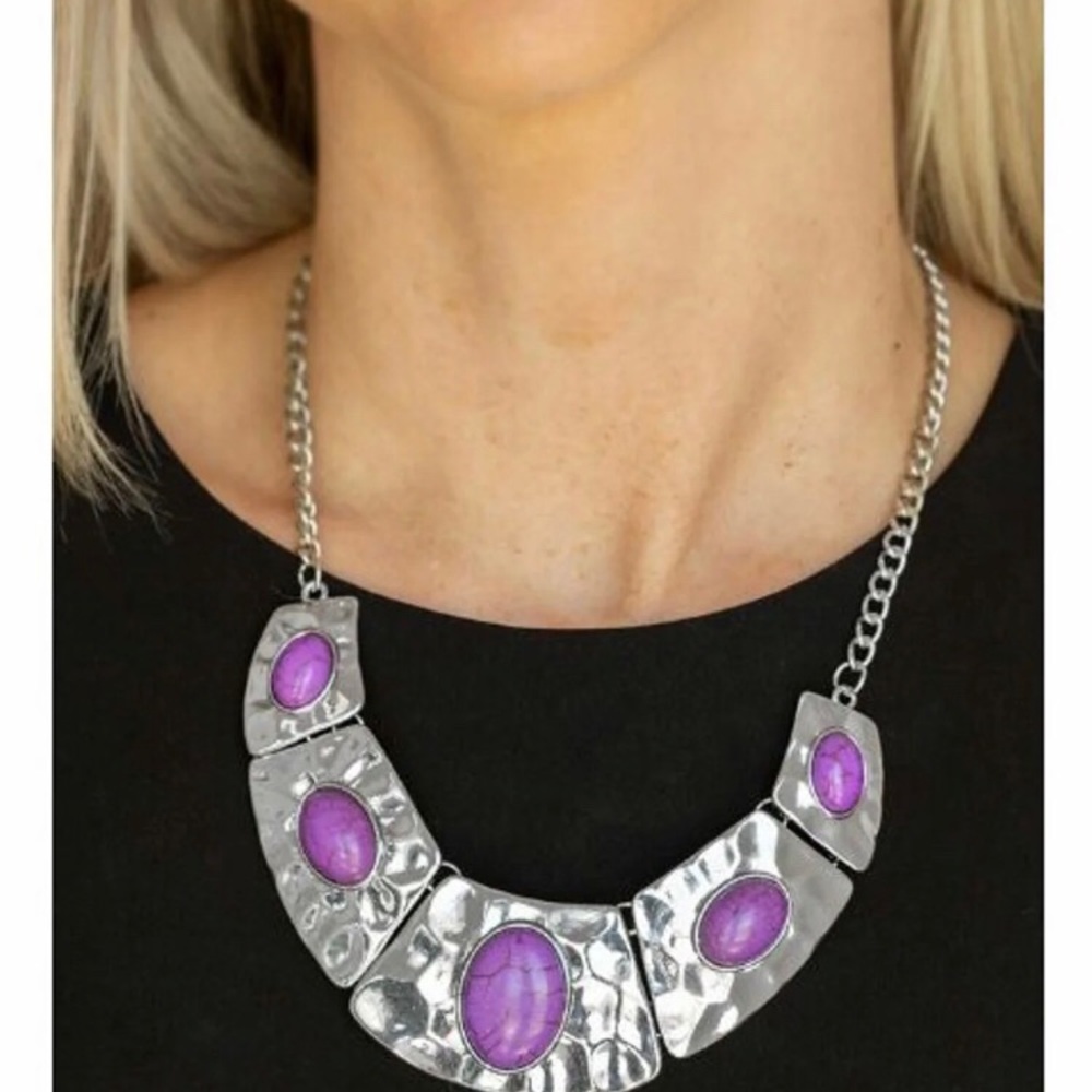 Ladies silver necklace set with purple stones.